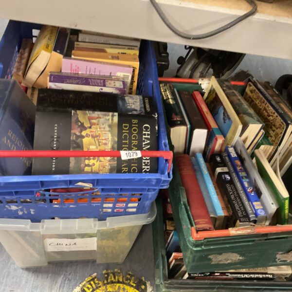 Four crates filled with a mixed collection of vintage books.