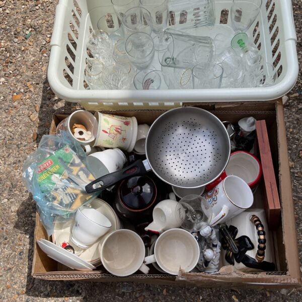 Mixed china and glass lot with cups, saucers, and serving pieces.