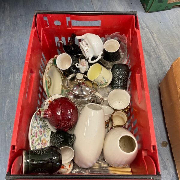 Mixed china lot with vintage vases and teacups on display.