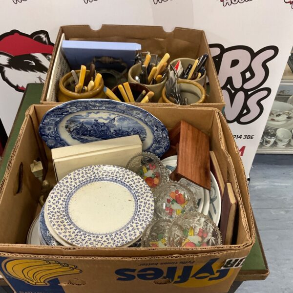 Mixed clearance lot with blue willow plates and stainless steel cutlery.