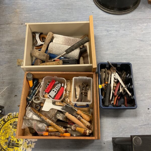Tray of mixed vintage hand tools including pliers and hammers.