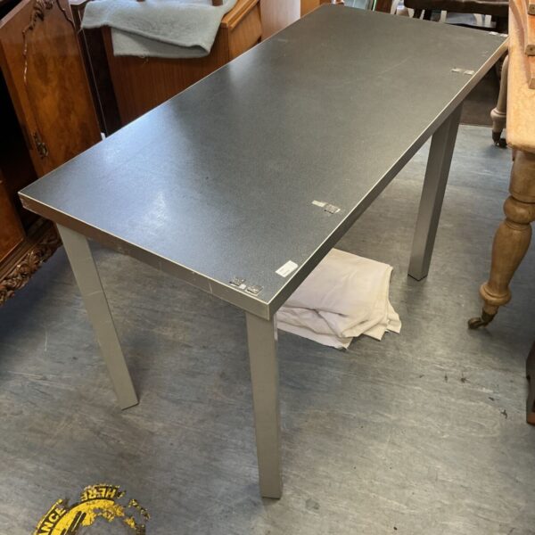 Modern grey speckled dining table with silver legs.