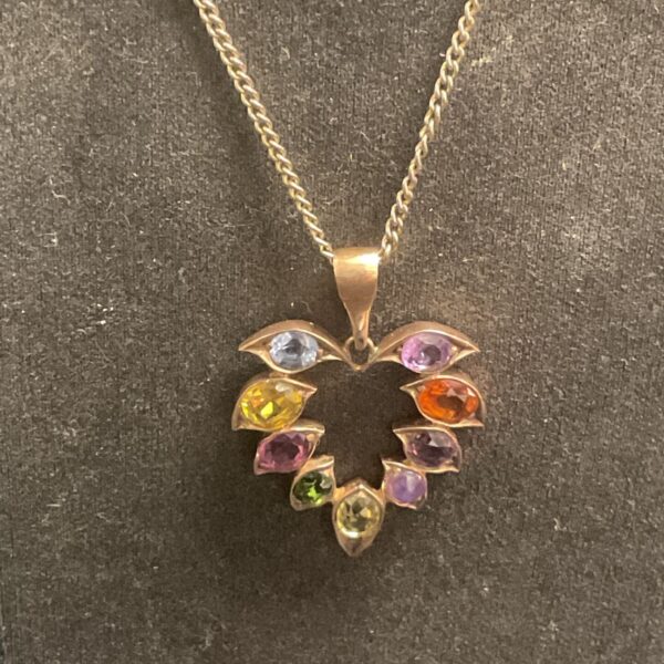 Gold vermeil multi-gemstone heart pendant on a delicate chain.