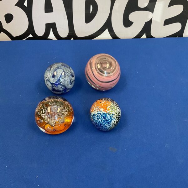 Lot of four colourful vintage Murano glass paperweights.