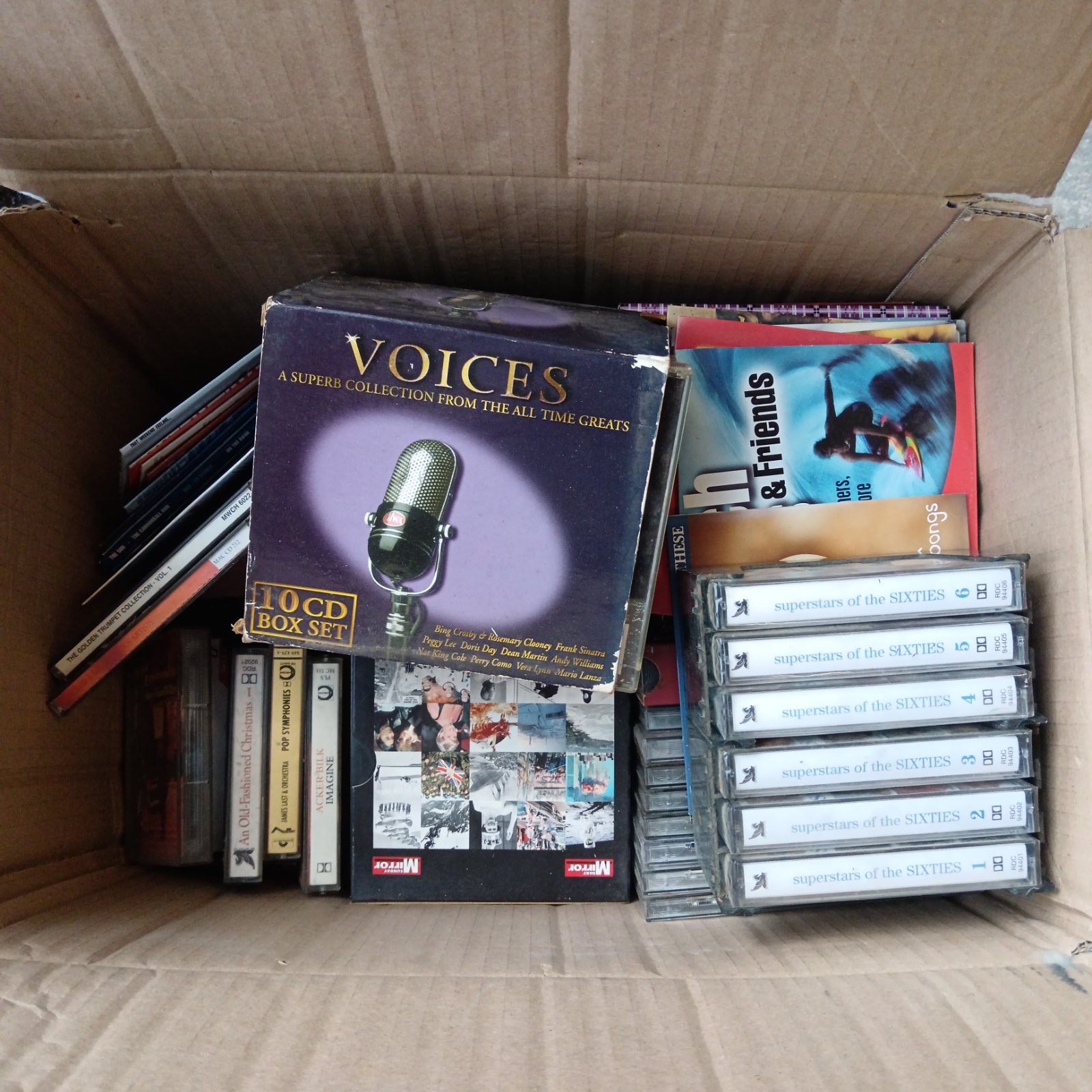 Mixed lot of vintage music CDs and cassettes for collectors.