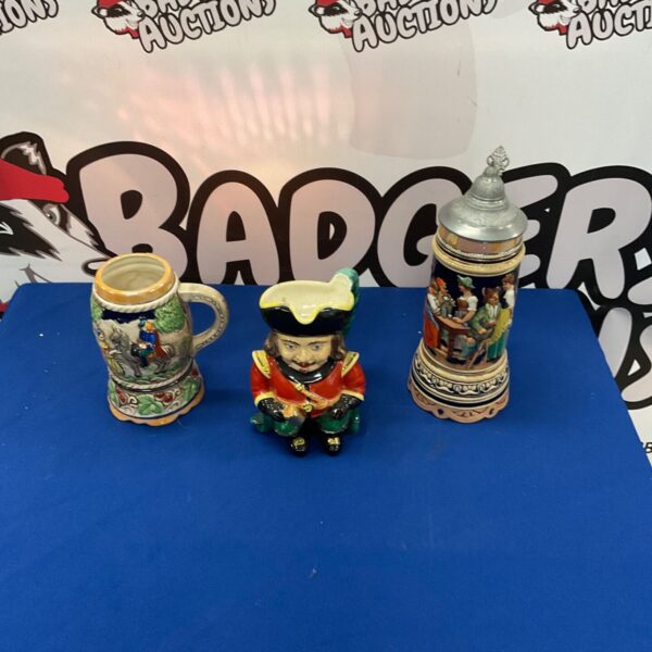 Vintage musical beer stein and Toby Jug set, collectible ceramic pieces.