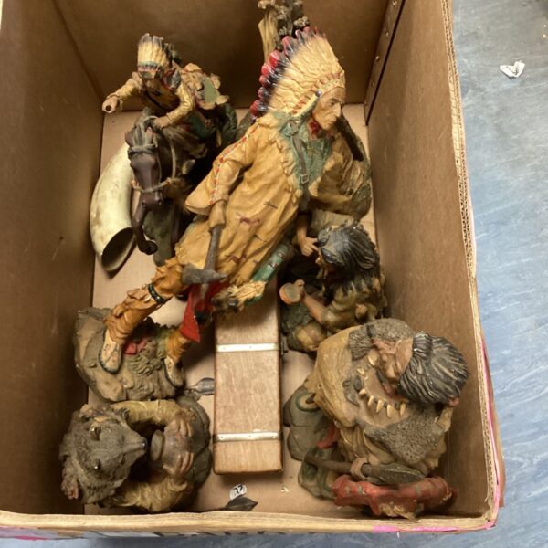 Vintage lot of Native American figurines with detailed clothing and headdresses.