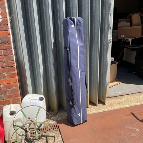 Navy blue pop up gazebo in a carry bag, garden shelter.