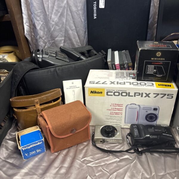 Nikon Coolpix 775 digital camera in a bundle of electronics.