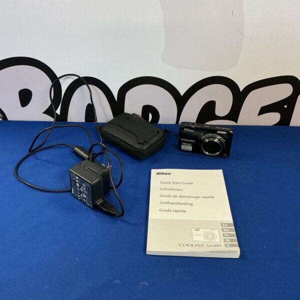Nikon Coolpix S6300 digital camera with charger and case.