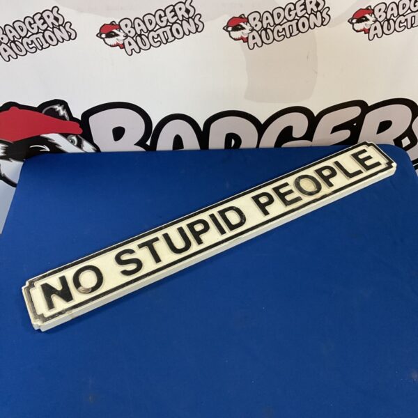 Humorous wooden street sign reading "No Stupid People".