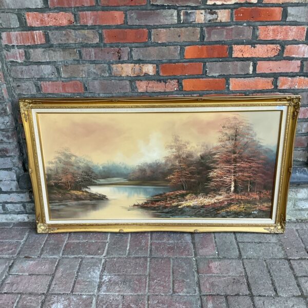 Large oil painting of an autumnal river scene with a gilt frame.
