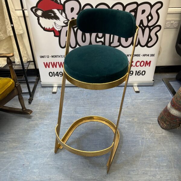 Green velvet bar stool with gold frame by Oliver Bonas.