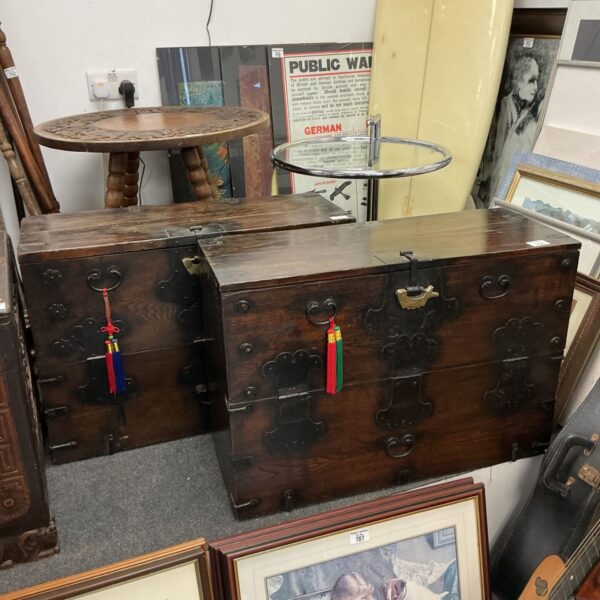 Pair of antique oriental oak chests with brass padlocks.