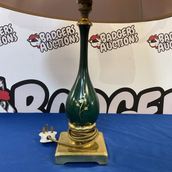 Vintage oriental table lamp with brass base and green body.