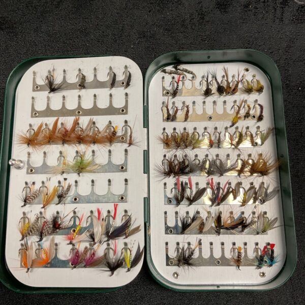 Open Osprey fly box displaying a large collection of vintage fishing flies.