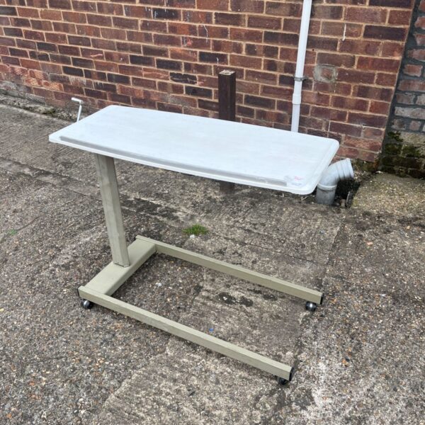 Adjustable height overbed table with rolling casters.