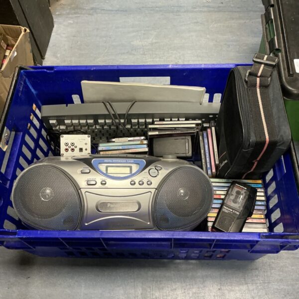 Vintage Panasonic boombox with Olympus recorder and CDs.