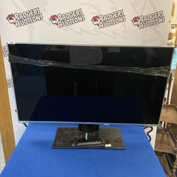 Panasonic smart TV with remote control for home entertainment.
