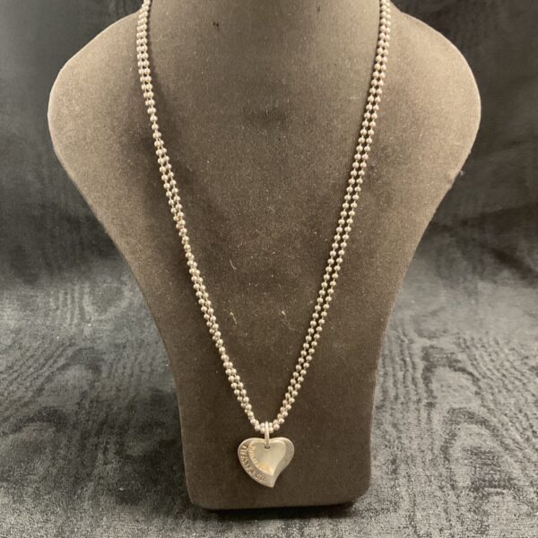 Pandora silver heart pendant necklace on display.