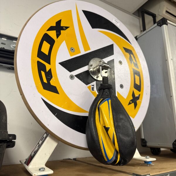 Black and yellow PDX speed bag mounted on a wall.