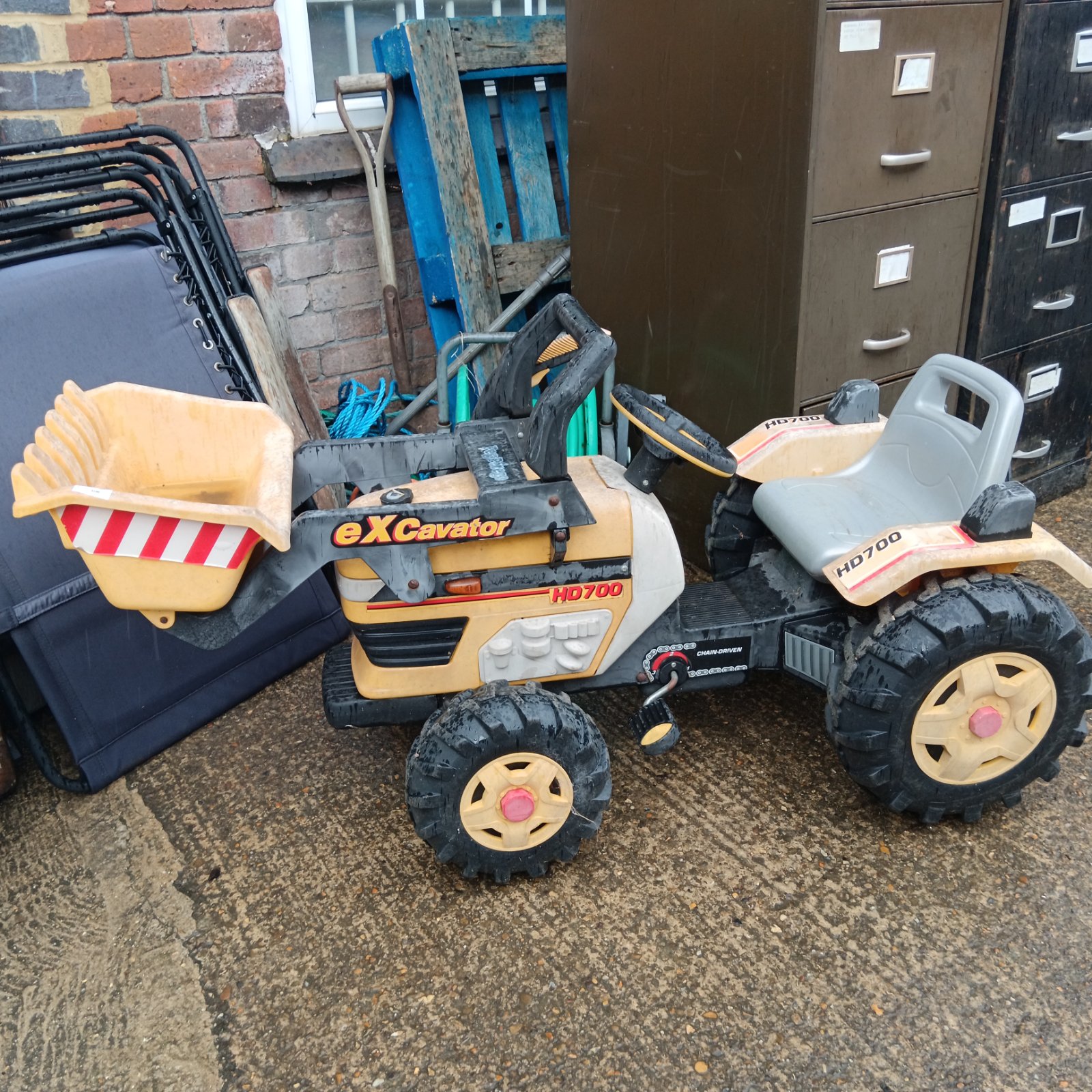 Yellow Peg Perego HD700 excavator ride-on toy for children.
