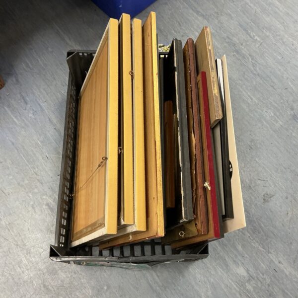 Crate filled with a mixed lot of vintage wooden picture frames.