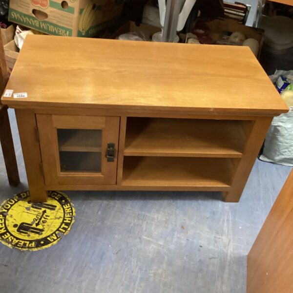 Vintage pine media cabinet with shelving for storage.