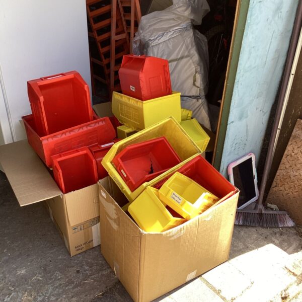 Lot of red and yellow plastic storage boxes for home organisation.