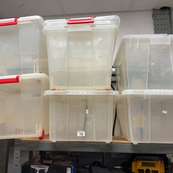 Lot of six large plastic storage boxes for household organisation.