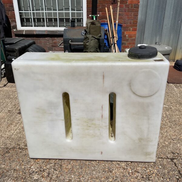 Large plastic water tank with handles for outdoor storage.