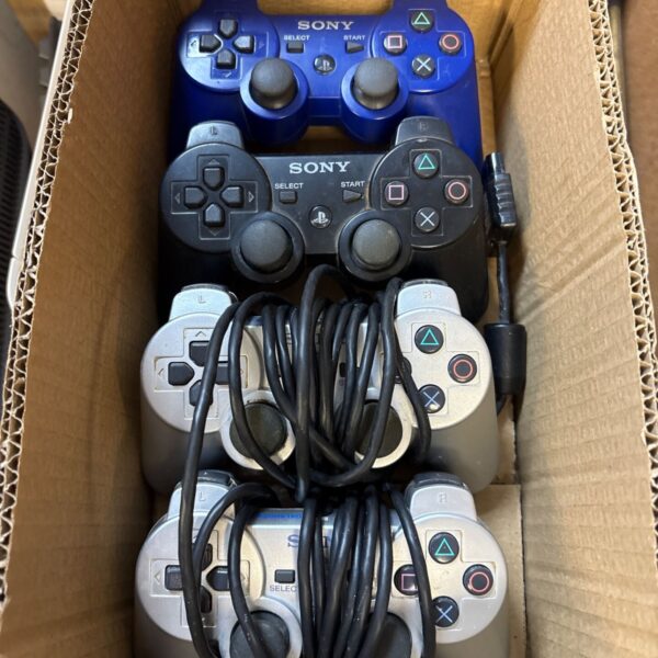 PlayStation controllers lot including DualShock 2 and 3 gamepads.