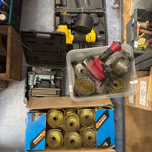 Lot of three pneumatic nail guns with a large quantity of nails.
