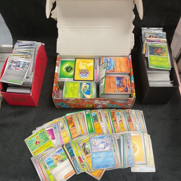 Large bundle of Pokemon cards including holographic cards for collectors.