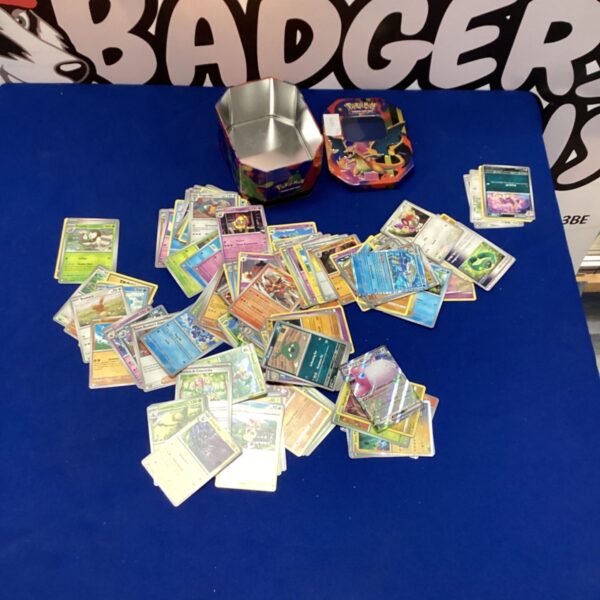 Pokemon trading cards lot with a tin for storage.