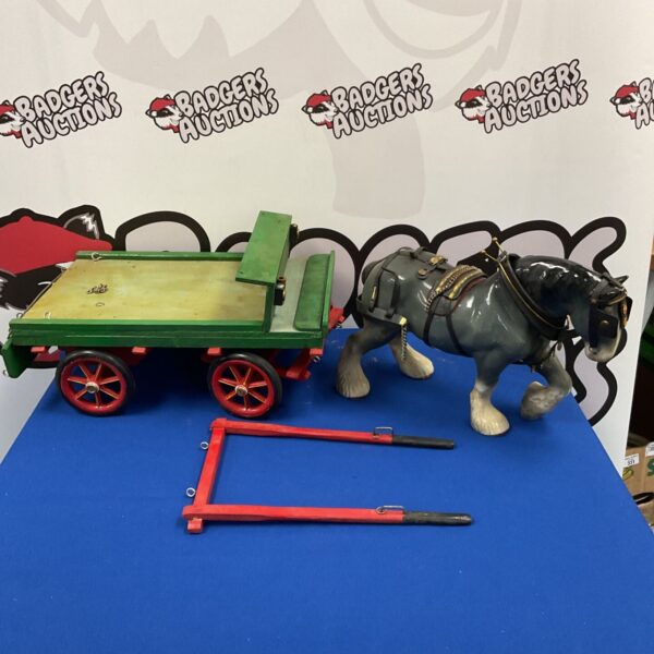 Vintage porcelain horse pulling a handmade wooden cart.