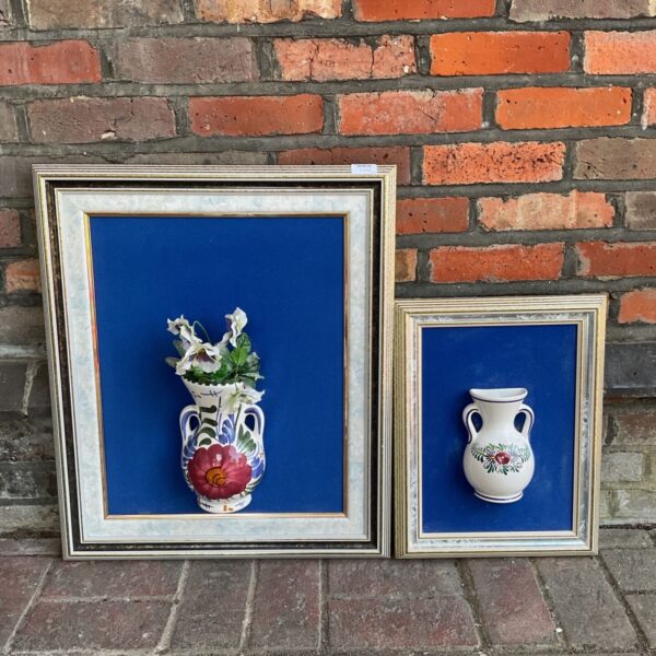 Framed pair of vintage Portuguese wall pocket vases with floral designs.