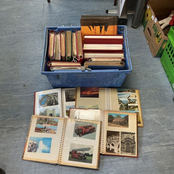 Vintage postcard albums filled with a large postcard collection.