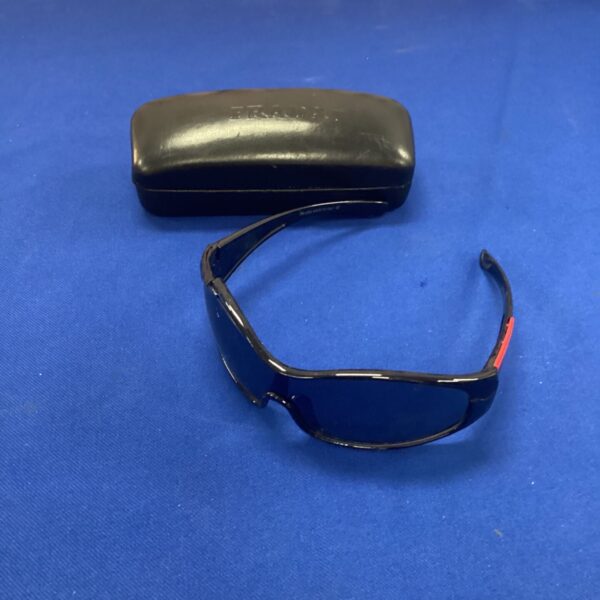Front view of stylish Prada sunglasses with dark lenses.