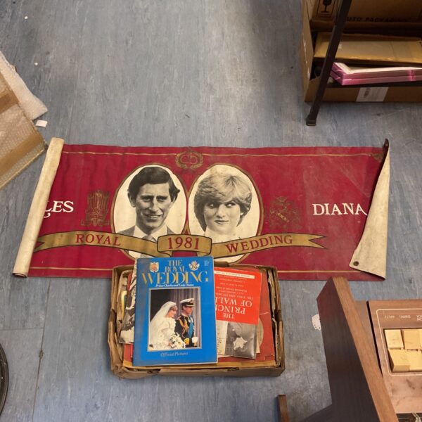 Vintage books and banner commemorating the Princess Diana wedding in 1981.