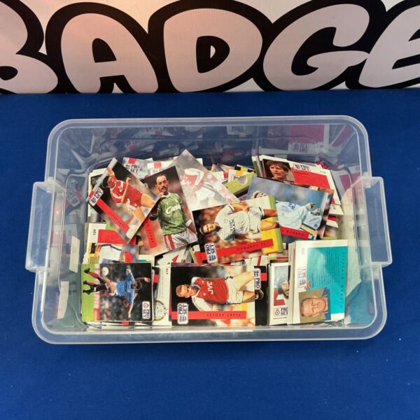 Assorted Pro Set trading cards in a plastic container.