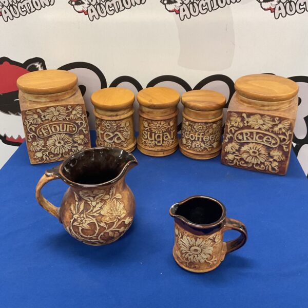 Vintage Quantock Devon pottery kitchen storage jars and jugs on display.