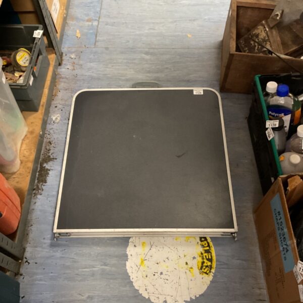 Used Quechua folding camping table for outdoor use.
