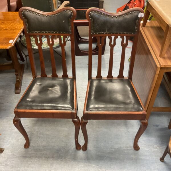 Dark leather Queen Anne dining chair with stud detailing.