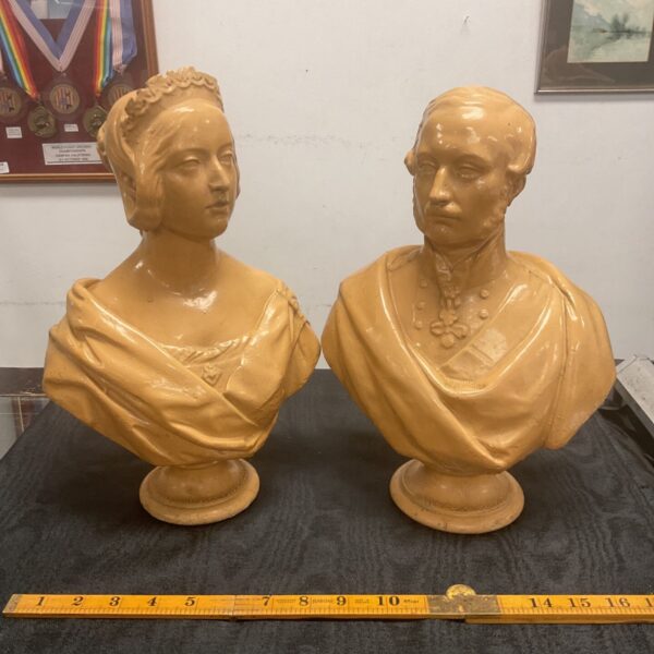 Antique ceramic busts of Queen Victoria and Prince Albert on display.