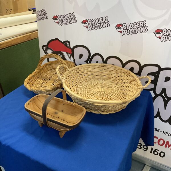 Three baskets including raffia and wooden vegetable basket for storage.