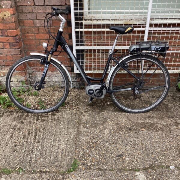 Black Raleigh Motus electric bike with pannier rack.
