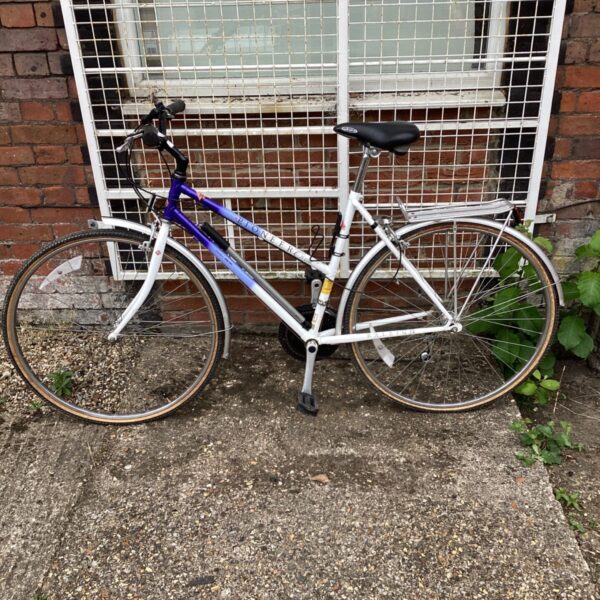 Purple and white Raleigh Pioneer women's hybrid bicycle.