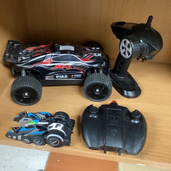 Red and blue RC cars lot with remote controls.