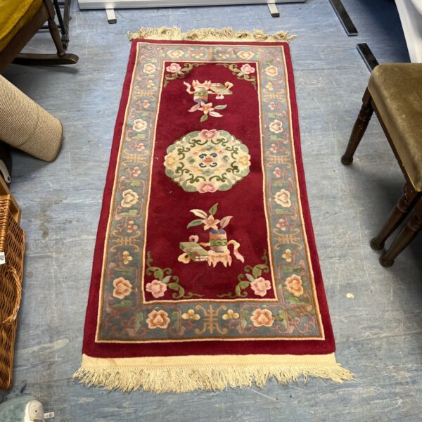 Vintage red Chinese rug with floral medallion design.